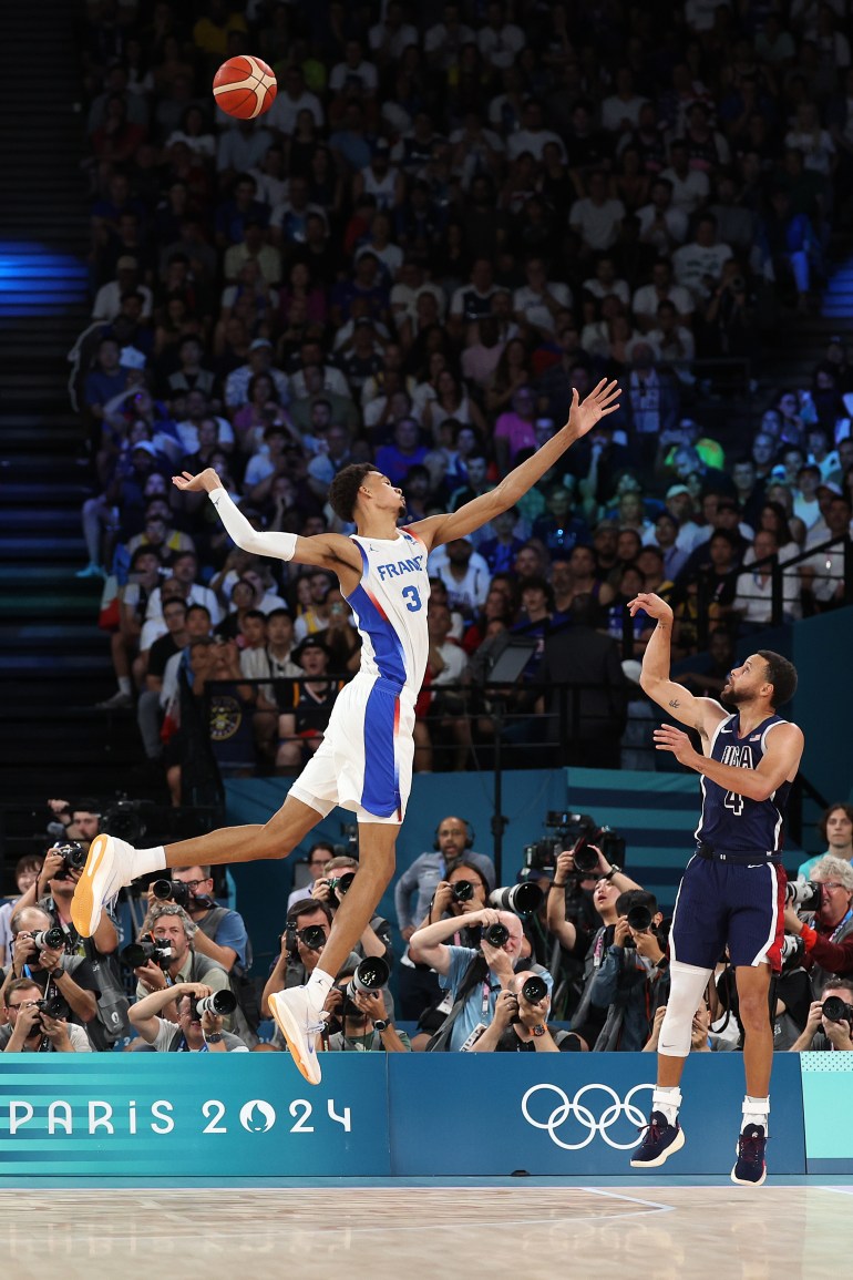 Basketball players on court.