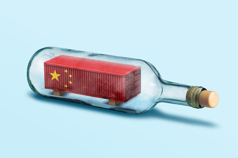A photo illustration shows a China-flagged shipping container inside a glass bottle.