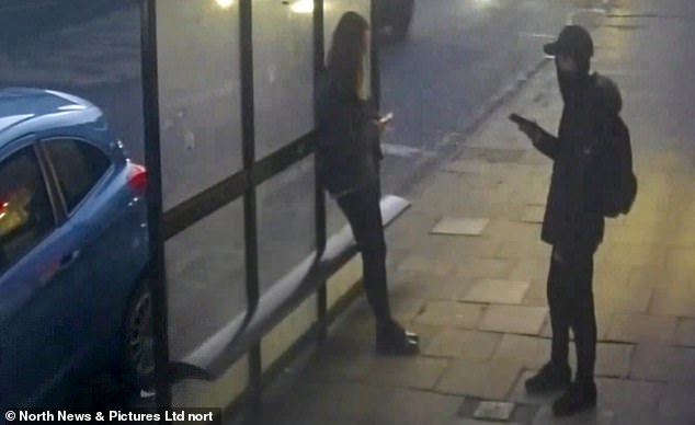MacPhail, wearing a mask and hat, is pictured approaching Holly as she stands at a bus stop looking at her phone, moments before he lured her into an alleyway and brutally stabbed her to death