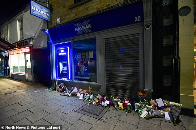 Floral tributes pictured at the scene of the stabbing a day after the knife attack