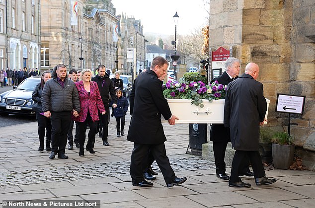 Holly's coffin is carried through during her funeral service at Hexham Abbey