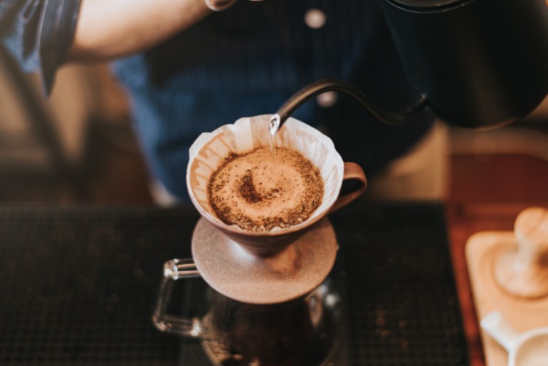 Barista making drip coffee