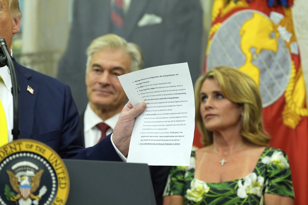 Donald Trump tenant un document concernant Kilmar Abrego Garcia lors d'une cérémonie au bureau ovale