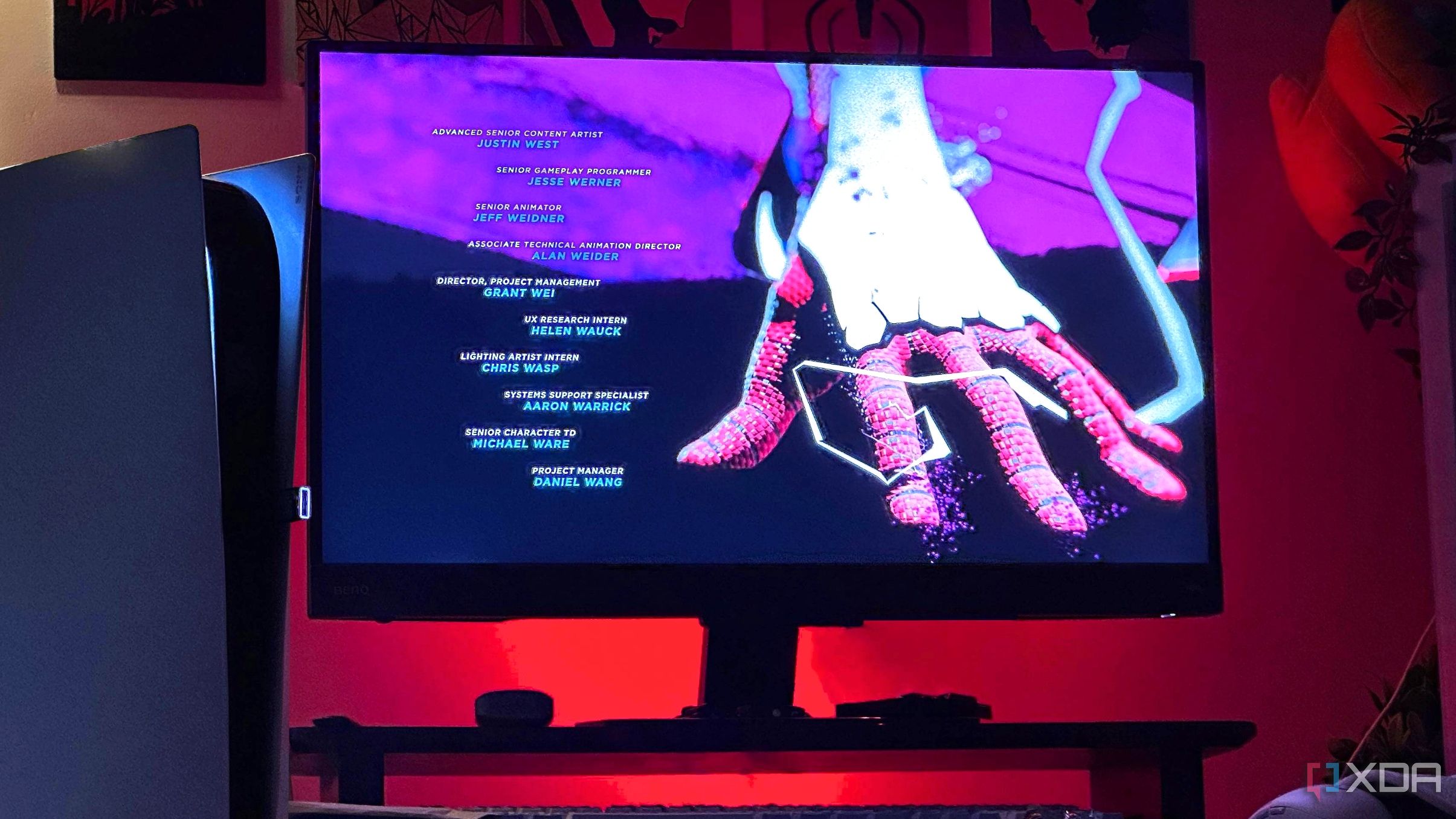 PlayStation 5 à côté d'un écran avec lumières rouges en arrière-plan