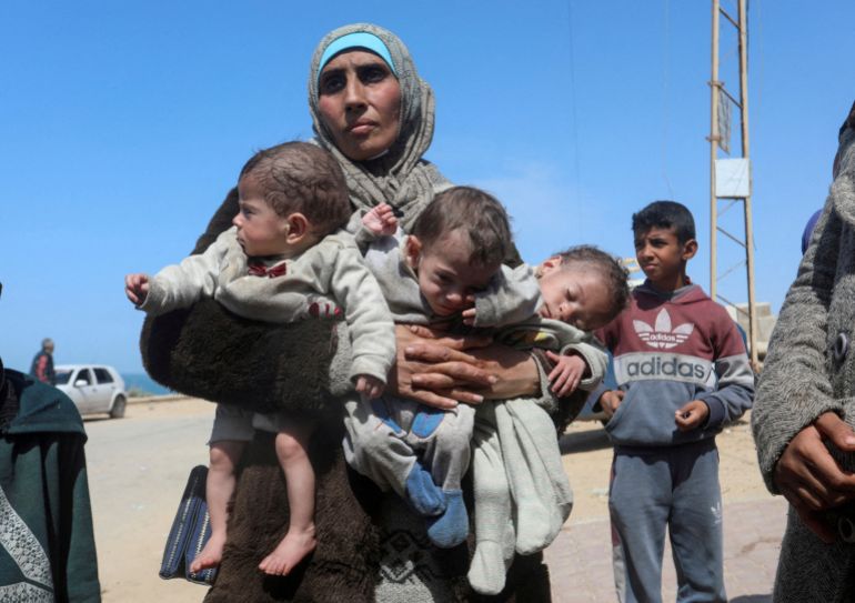 Femme palestinienne et ses enfants quittant l'hôpital Al Shifa après un raid
